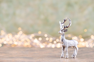 Christmas reindeer on bokeh silver background. Christmas or New Year minimal concept.