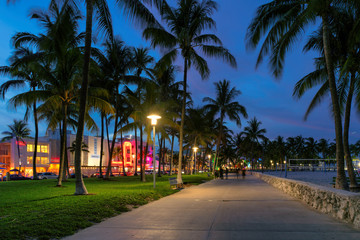 Hotels and restaurants at night on Ocean Drive, world famous destination. Nightlife in Miami Beach,...