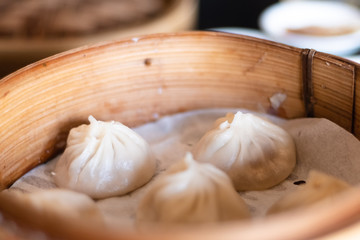 Close up white dim sum ha gow on wooden basket. (traditional Cantonese dumpling) chinese food.