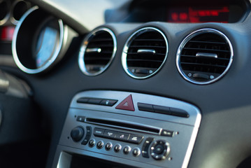 Interior of a car. Car dashboard with buttons and CD player. 