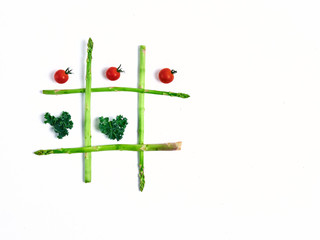 tic tac toe with food, asparagus kale, tomato, top view
