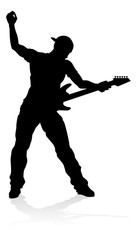 A guitarist musician in detailed silhouette playing his guitar musical instrument.