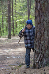 boy behind a pine tree,baby hiding behind a tall tree in the forest
