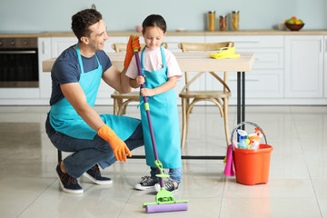 Father and daughter cleaning kitchen together