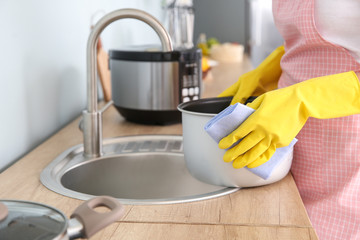 Woman washing modern multi cooker in kitchen