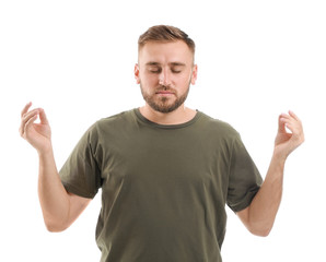 Fototapeta premium Meditating young man on white background