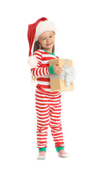 Cute little girl in Santa hat and with Christmas gift on white background