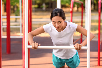 Fototapeta premium Sporty Asian woman training outdoors