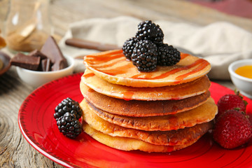 Tasty pancakes with berries on plate