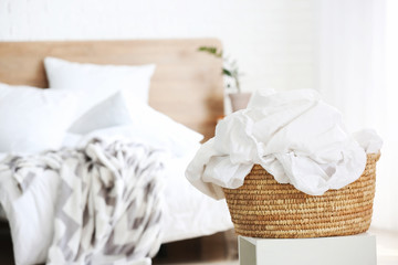 Fototapeta na wymiar Basket with laundry in bedroom