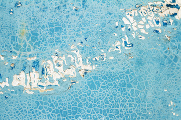 Cracked blue paint on concrete background texture