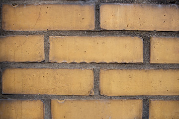 Old red brick wall. Old concrete wall. The facade of the house built of solid stone cement