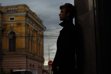 portrait of an attractive young man in a blue suit in the city