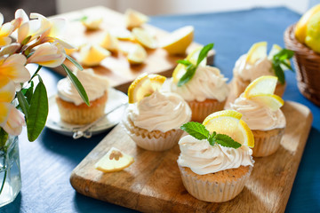 Lemon cupcakes with poppy seeds, white butter cream and  slice of lemon