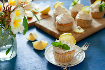 Lemon cupcakes with poppy seeds, white butter cream and  slice of lemon
