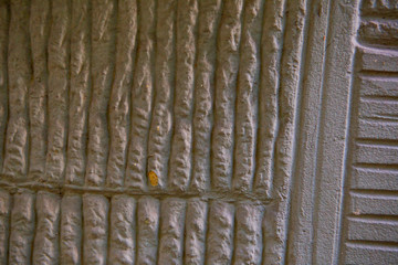 Old red brick wall. Old concrete wall. The facade of the house built of solid stone cement