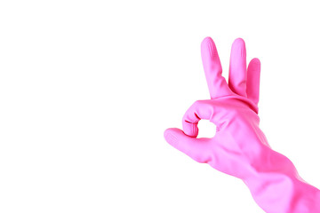 Fototapeta na wymiar Female hand in pink rubber gloves shows the sign OK on a white background