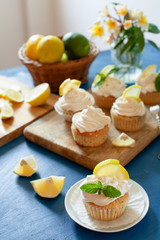 Lemon cupcakes with poppy seeds, white butter cream and  slice of lemon