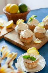 Lemon cupcakes with poppy seeds, white butter cream and  slice of lemon