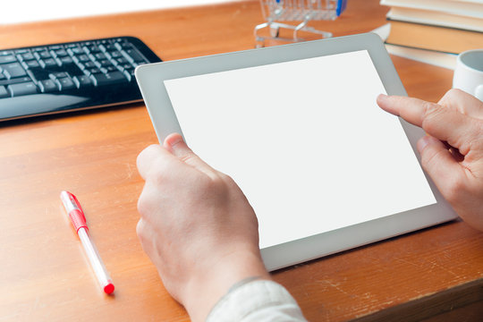 A man in shirt making online shopping with a blank screen white tablet
