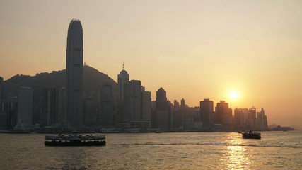 Skyline of Hong Kong during sunset at the river with Skyscraper buildings in Hong Kong, Asia.