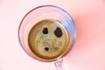 Coffee with a boo expression from the foam. Funny photo.