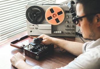 Special agent holds field telephone set USSR. Officer wiretapping   on the reel tape recorder. KGB...