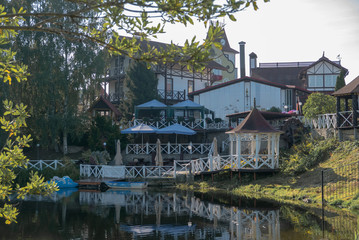 Fototapeta na wymiar Beautiful house on a bank of lake at summer morning.