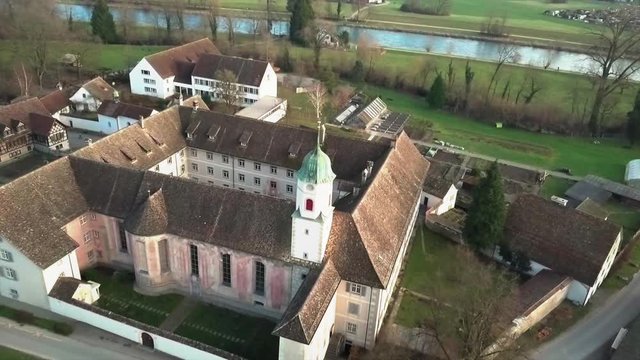 Aerial drone shot flying towards Fahr Monastery in Unterengstringen, Switzerland