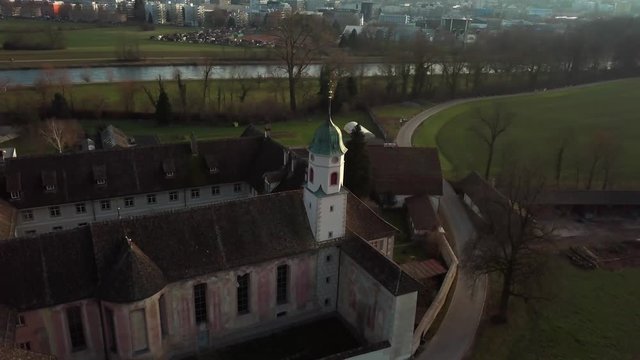 Aerial drone shot orbiting around Fahr Monastery in Unterengstringen, Switzerland