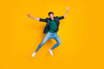 Full size photo of satisfied excited enthusiastic man jump enjoying free time on holidays good-looking wear modern trendy outfit isolated over yellow color background