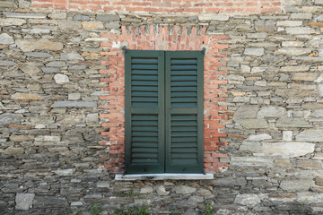 Fototapeta na wymiar old window in brick wall, Old wooden window, old building with brick stone background, old window in the wall, isolated for a texture, 