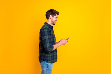 Profile photo of blogger guy holding telephone in hands checking instagram followers wear casual...