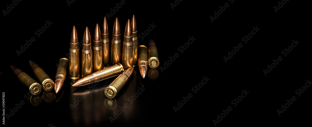 Sticker bullet isolated on black background with reflexion. rifle bullets close-up on black back. cartridges