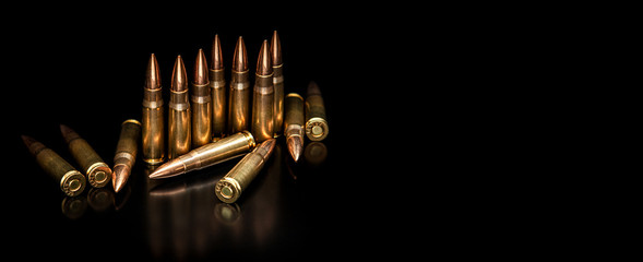 Bullet isolated on black background with reflexion. Rifle bullets close-up on black back....