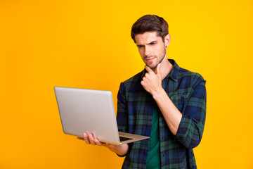 Photo of amazing guy with notebook in hands think over important business startup wear casual checkered shirt isolated yellow color background