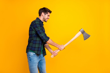 Profile photo of cool guy in process of cutting wooden materials with big ax wear casual plaid...