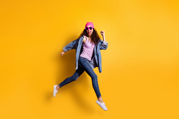 Full body photo of stylish wavy lady jumping high running quickly to shopping center wear casual trendy clothes isolated yellow color background