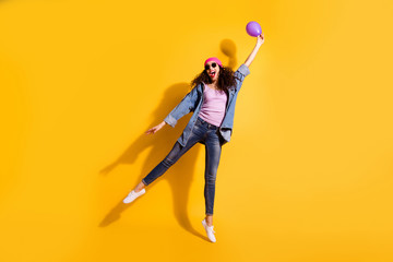 Fototapeta na wymiar Full length photo of nice wavy lady holding air balloon in hand begin to raise up wear casual trendy clothes isolated yellow color background