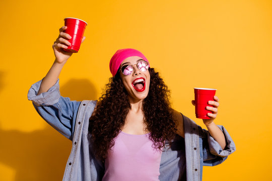 Photo of stylish lady raising red cups with beer chilling with friends wear casual trendy clothes isolated yellow color background
