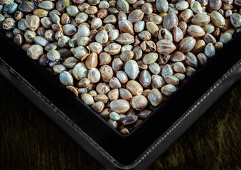 Hemp seeds in a black square plate