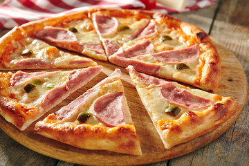 Pizza Restaurant Menu - Delicious Fresh Spicy Pizza with Ham and Chili Pepper. Pizza on Rustic Wooden Table with Ingredients