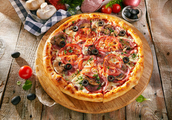 Pizza Restaurant Menu - Delicious Fresh Pizza with Sausages, Tomatoes and Mushrooms.Pizza on Rustic Wooden Table with Ingredients