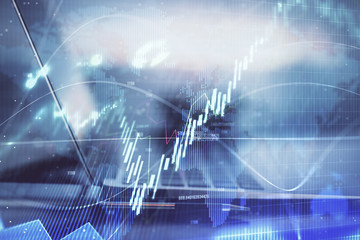 Forex graph hologram on table with computer background. Multi exposure. Concept of financial markets.