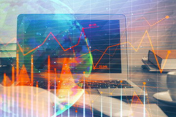 Financial graph colorful drawing and table with computer on background. Multi exposure. Concept of international markets.