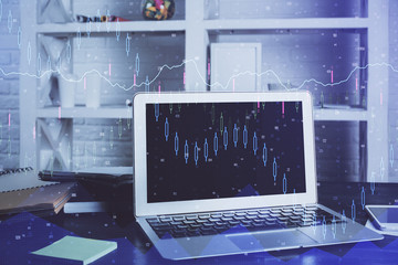 Financial graph colorful drawing and table with computer on background. Multi exposure. Concept of international markets.
