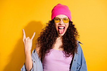 Portrait of excited girl have free time weekends grimace true rocker wear modern pink cap tank-top isolated over yellow color background