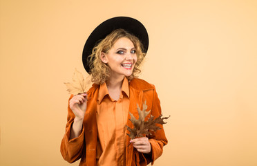 September. Happy girl with autumn leaf. Autumnal foliage. Autumn sale. Fashion woman with leaves. Fashion trends for fall. Leaf fall. Autumn woman with golden leaves. Autumn clothing and color trends.