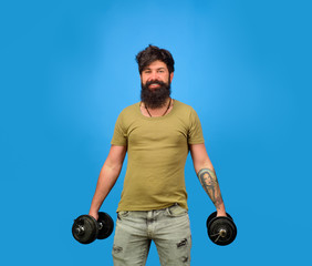 Athletic man doing exercise with dumbbells. Handsome man lifting dumbbells at gym. Sporty man with dumbbells. Strength and motivation. Athletic guy with dumbbells. Strong athletic man fitness model.