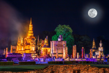 Fototapeta na wymiar Beautiful scene light color Sukhothai Co Lamplighter Loy Kratong Festival party at The Sukhothai Historical temple park covers the ruins of Sukhothai, in what is now Northern Thailand. With full moon